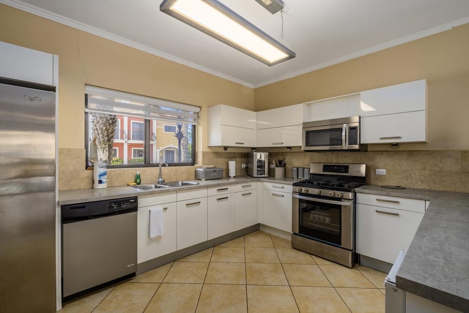 A spacious kitchen layout with a fridge, stove, oven, and microwave.