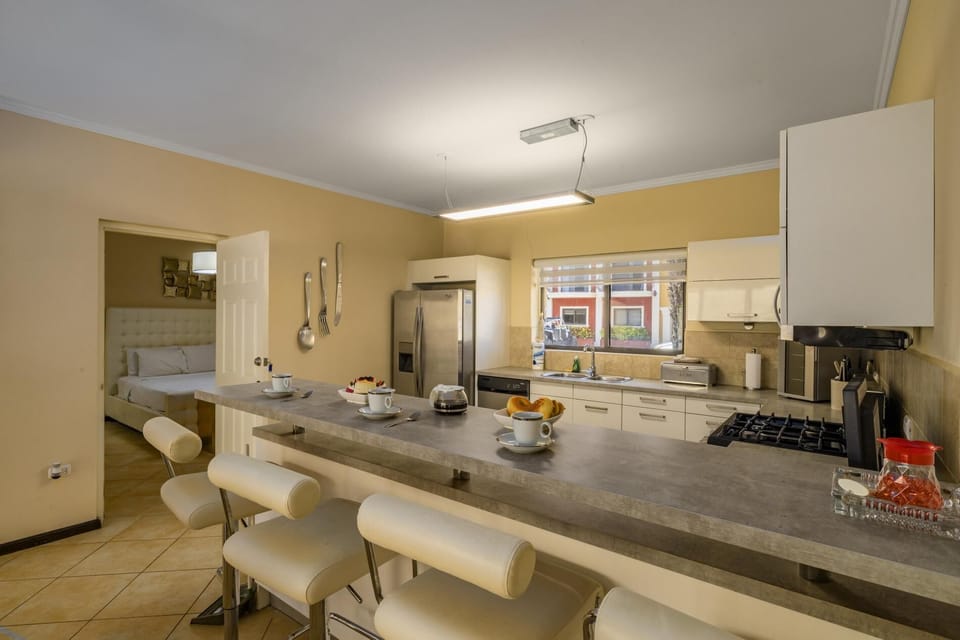 A spacious kitchen layout with a fridge, stove, oven, and microwave.