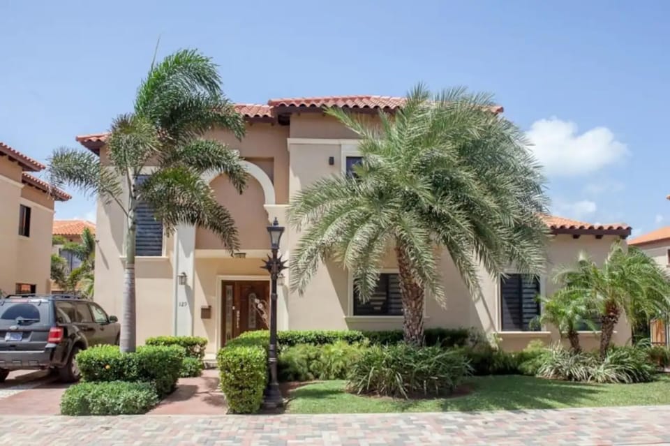 Abundant plants and tall trees will greet you in front of the house.