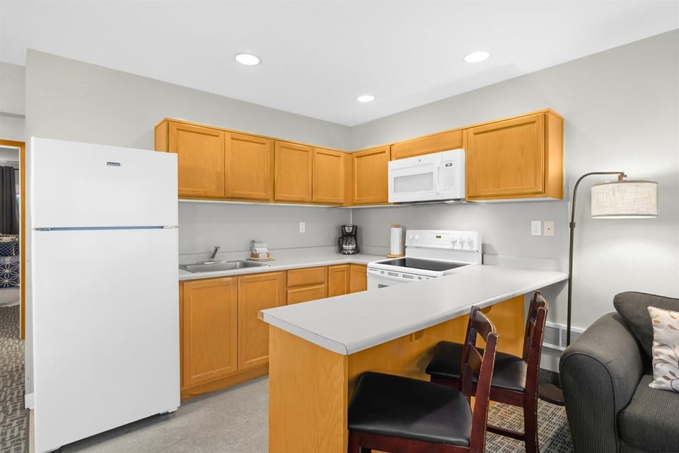 The kitchen is fully stocked with cookware and essentials