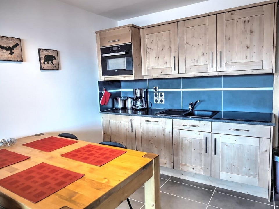 Kitchenette with full size dishwasher, hob, fridge and oven