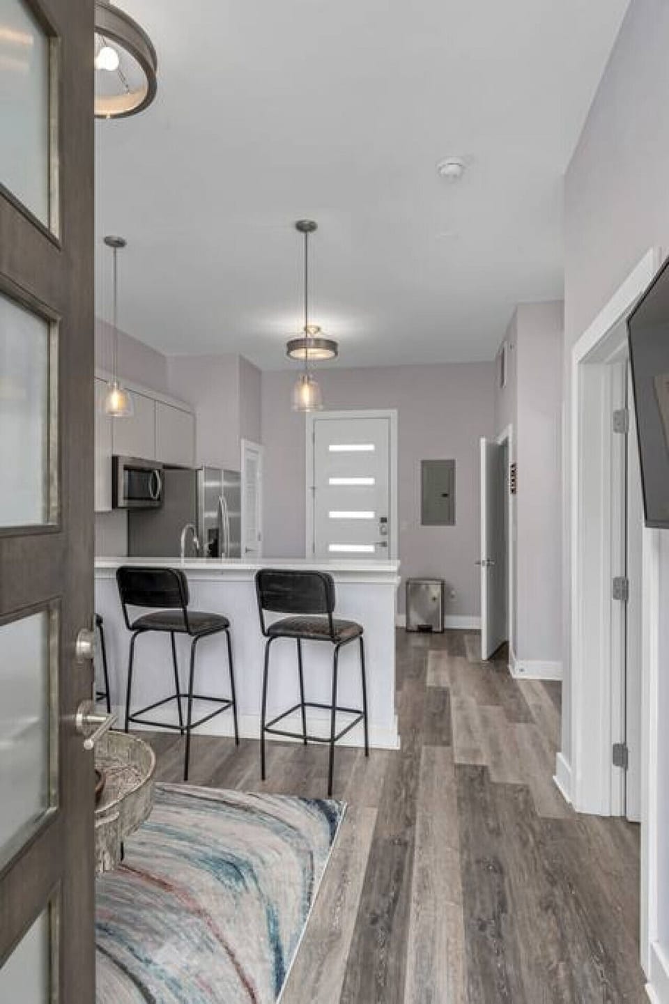 Cozy living room area with a pull-out sofa plus Smart TV with apps. Seating for 5 at the kitchen counter.