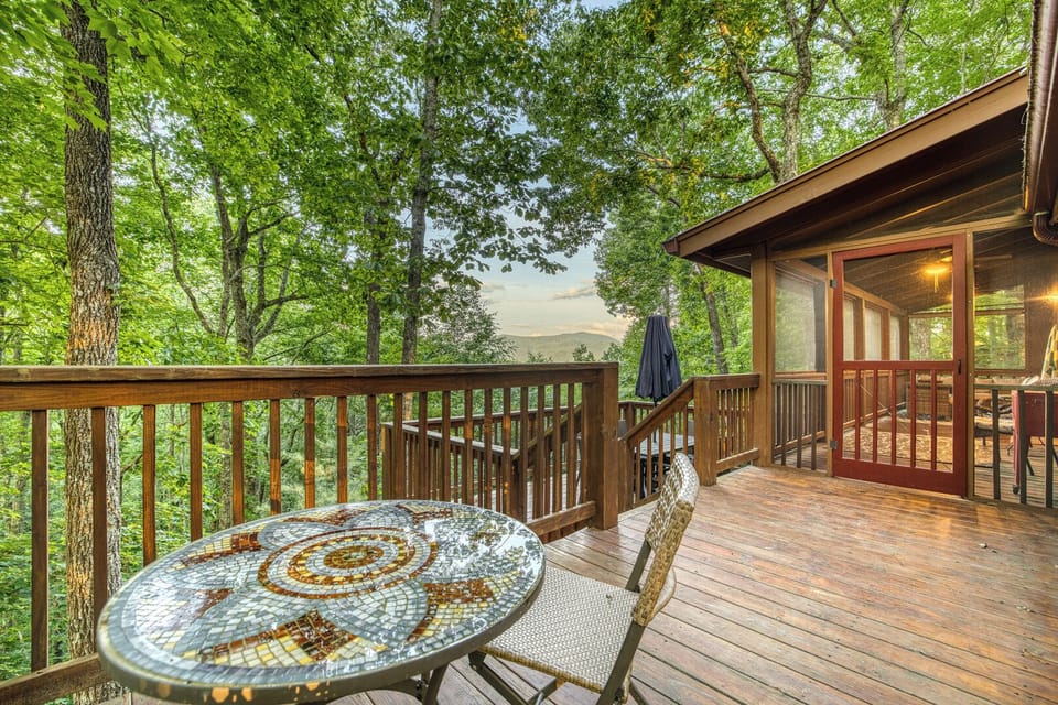 Cozy additional deck with a charming café table for two, offering stunning mountain views—perfect for intimate breakfasts, quiet moments, or evening drinks surrounded by nature’s beauty.