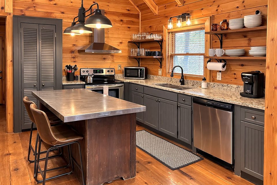 Recently updated and fully stocked, this warm, rustic kitchen features modern finishes, open shelving, stainless appliances, and everything you need to cook, dine, and settle in comfortably during your stay.