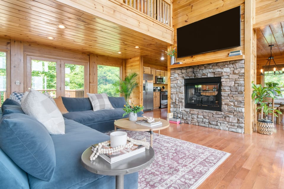 Spacious living room with vaulted ceilings and a fireplace.