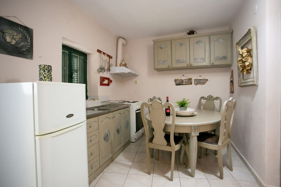 Kitchen and dining table of Cozy country house,4 guests,Renovated,Near tavern,cafe, beach,Mani,Greece