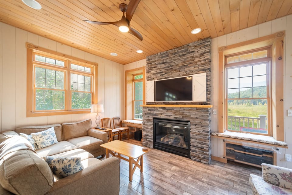 The living room features a large gas fireplace and a Smart TV.