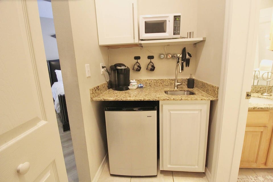 The kitchenette has a microwave, small fridge and sink.