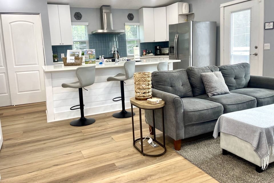 The open floor plan, soaring ceilings and windows all around give this home a bright airy feel
