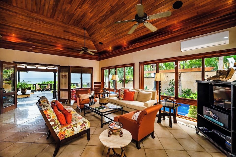 Elegant living room in this Tamarindo villa with ocean views, seamlessly connecting indoor spaces to the terrace—perfect for a beach front vacation rental experience.