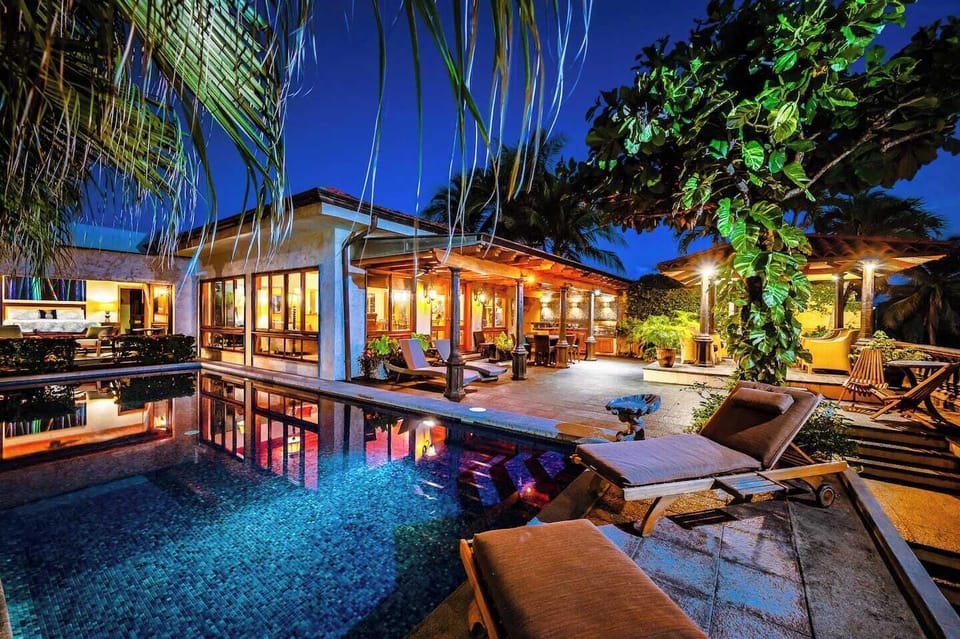 Enjoy the pool in this Tamarindo vacation rental, surrounded by lush gardens and modern Costa Rican architecture—a serene space for family or group stays.
