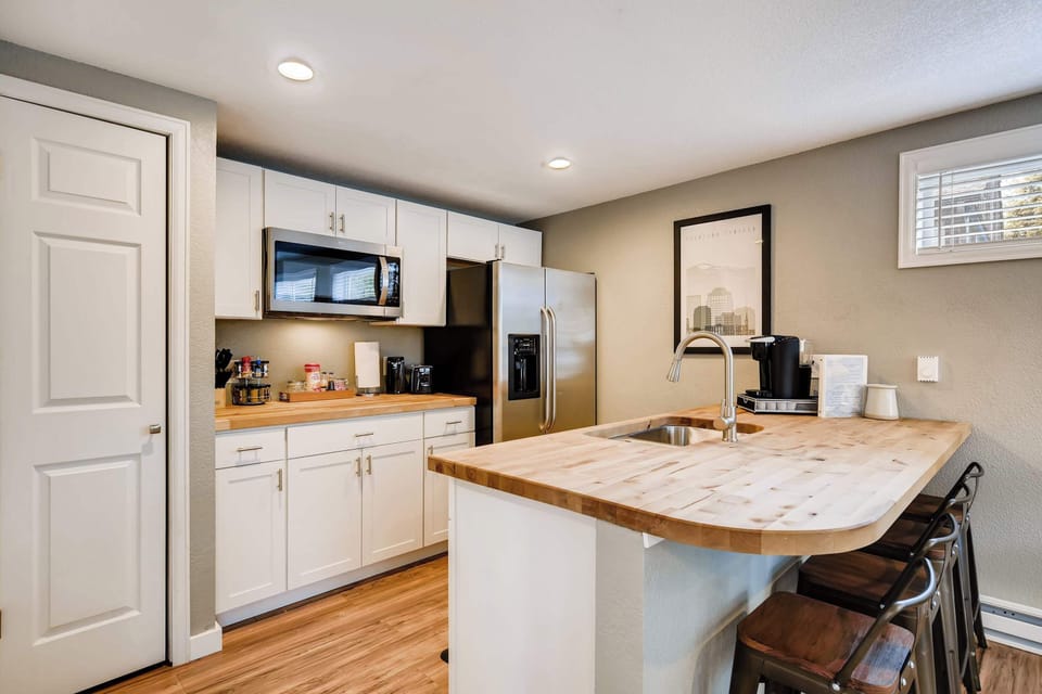 Fully stocked kitchen with modern appliances, an induction cooktop, and a spacious island—perfect for enjoying a meal or getting some work done.






