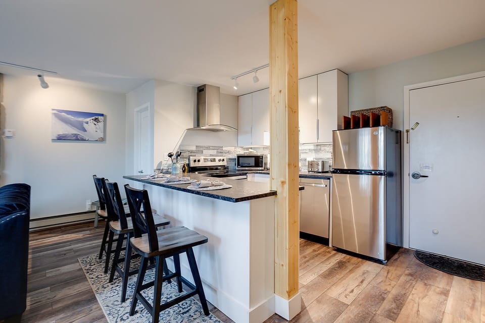 Your modern kitchen awaits with sleek stainless appliances, granite countertops, and a convenient breakfast bar perfect for morning coffee or casual dining.