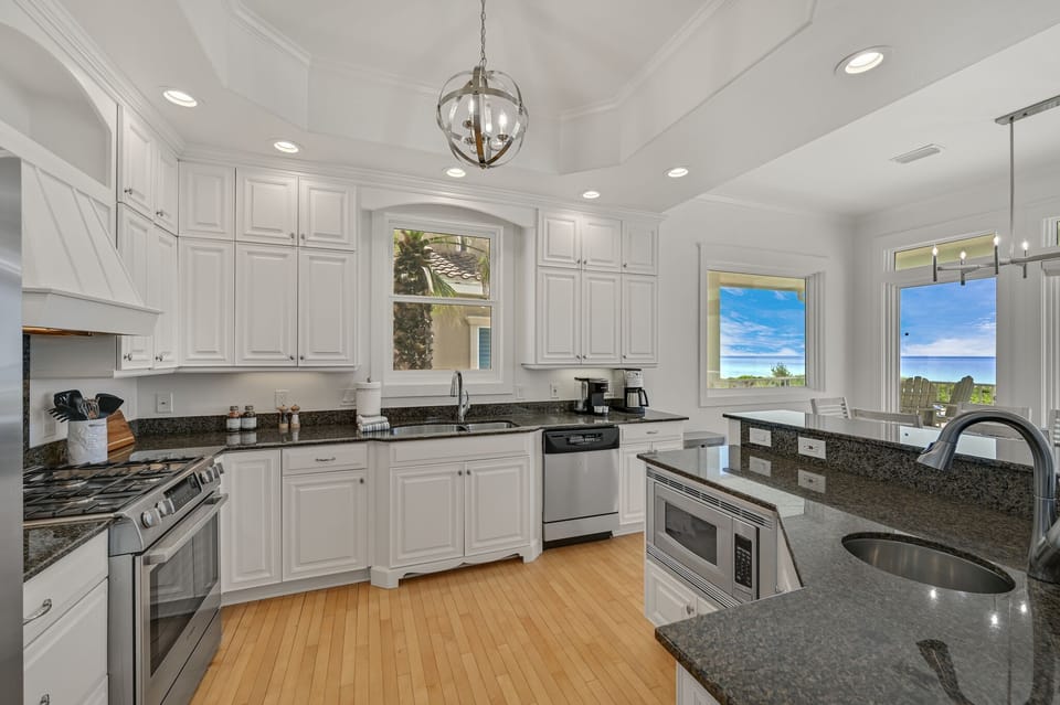 Open Kitchen with Island Breakfest Bar, Dual Sinks, Microwave, Gas Range, Oven, Drip and K-Cup Coffee Machines.