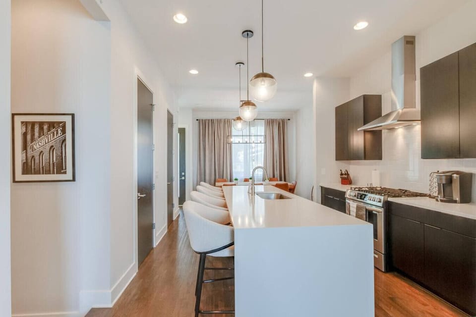 Open kitchen and living space with a center island and stylish modern finishes