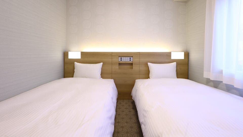 Basic Twin Room, 2 Twin Beds | Down comforters, in-room safe, desk, laptop workspace