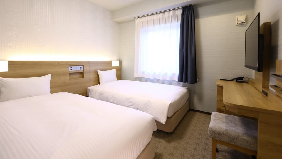 Basic Twin Room, 2 Twin Beds | Down comforters, in-room safe, desk, laptop workspace