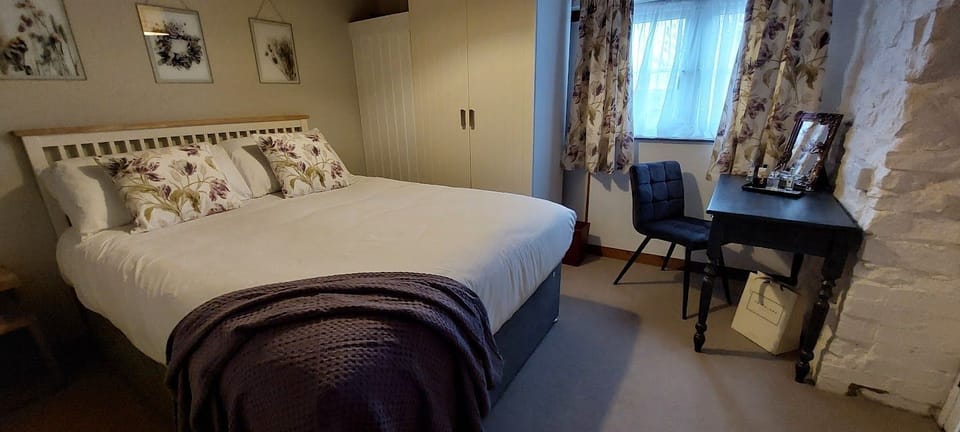 bedroom with kingbed, wardrobe and dressing table