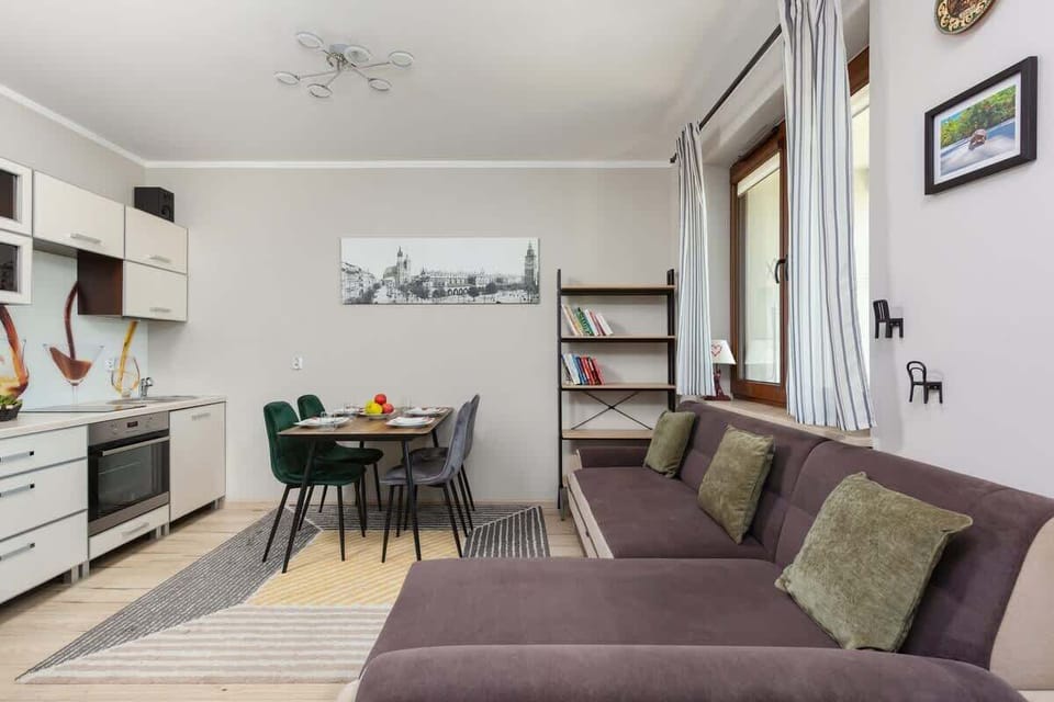 The elegant living room featuring a double sofa bed, perfect for relaxing or sleeping.