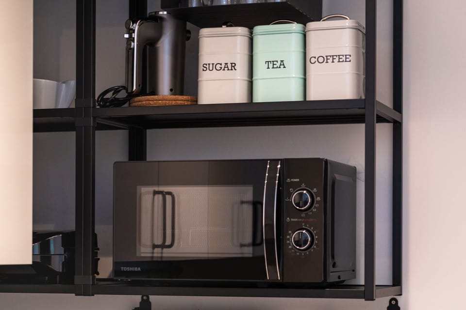 Kitchenette with plenty of kitchen utensils and dishes. 