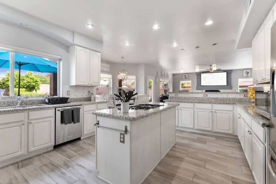 Bright, spacious kitchen with granite counters, stainless appliances, and a large island—your perfect spot for cooking vacation meals together.