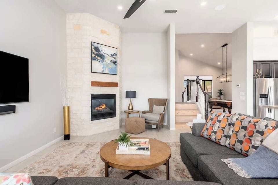 Unwind in your bright, open living space featuring a cozy fireplace, modern furnishings, and elegant touches that make every moment feel like home.