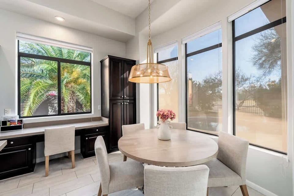 Gather around this welcoming dining nook bathed in natural light, where your morning coffee or evening meal feels effortlessly relaxed with peaceful garden and courtyard views.