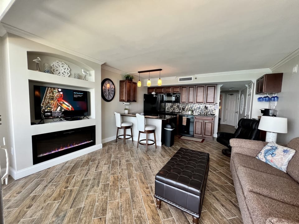 Spacious open living area with kitchen, fireplace & smart TV