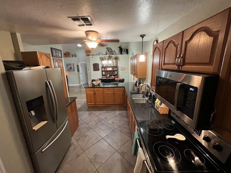A modern kitchen with many amenities including coffee bar.