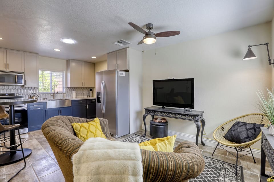 living area with ceiling fan, smart tv, couch & lighted reading area