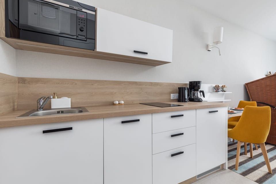 The sleek design of the kitchenette blending seamlessly with the living area.
