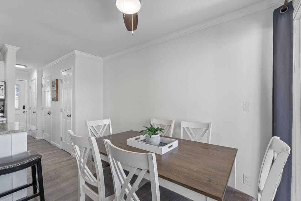 Gather around this inviting dining table for six, where you'll enjoy leisurely meals together in a bright, clean space with modern finishes and easy access to the kitchen.