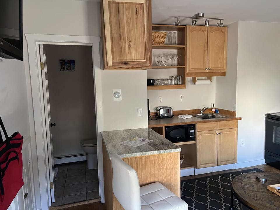 Door to full bathroom with stall shower