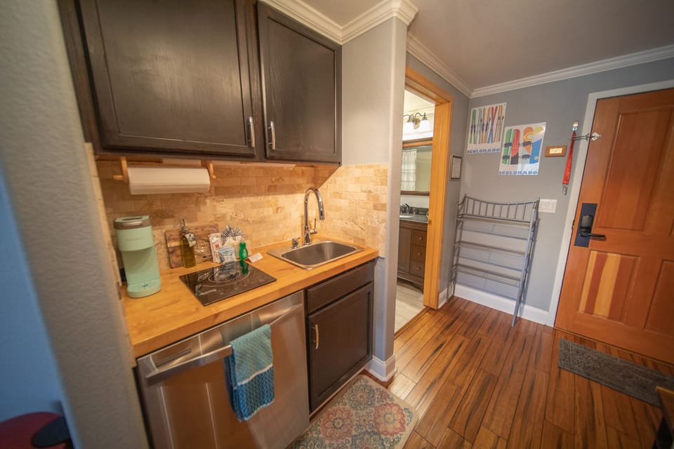 Kitchenette with a dishwasher, plus a cook top