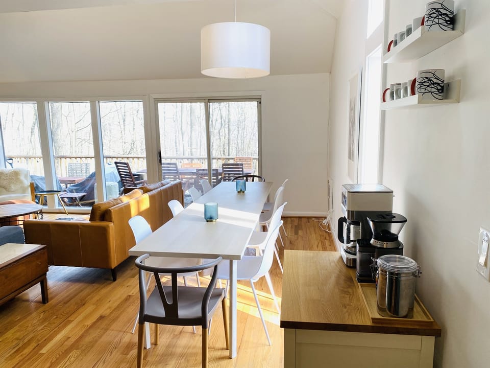Organic whole bean coffee, burr grinder, and coffee maker. Dining tables are great -- spread out to eat, play a game, do a puzzle, or work from Aerie!