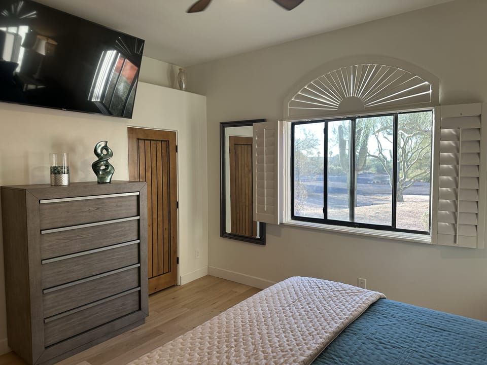 Guest suite 2 with king bed, TV, Sonos and ceiling fan with private sink area 