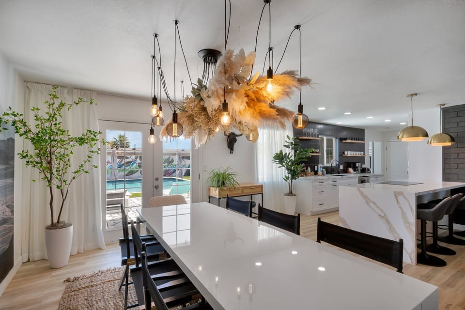 The elegant chandelier adds a warm glow to this spacious dining area made for gathering.