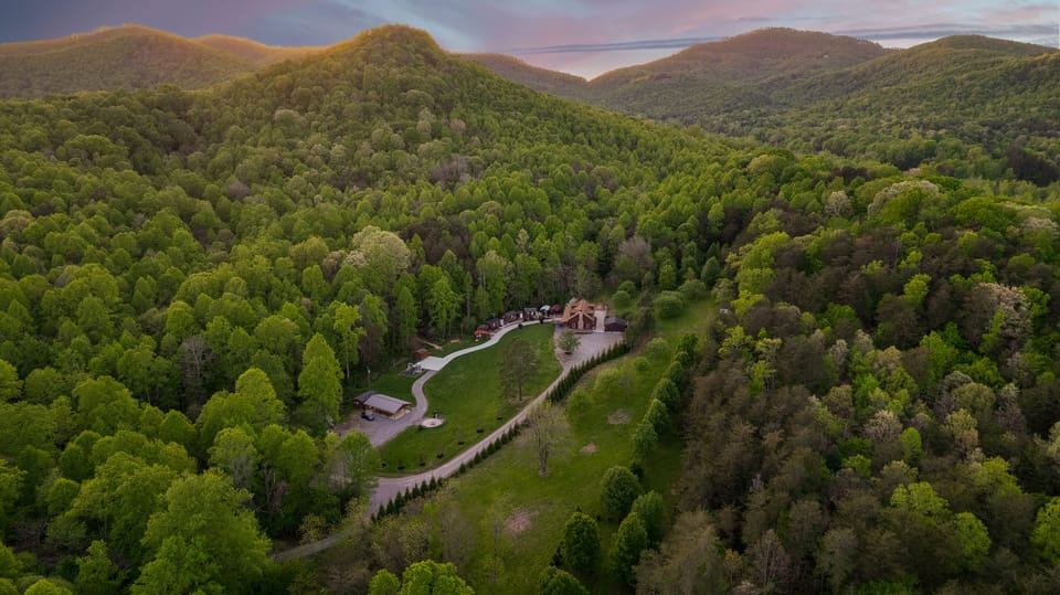 Aerial view showcasing the private setting of this gorgeous cabin snuggled in the mountains.