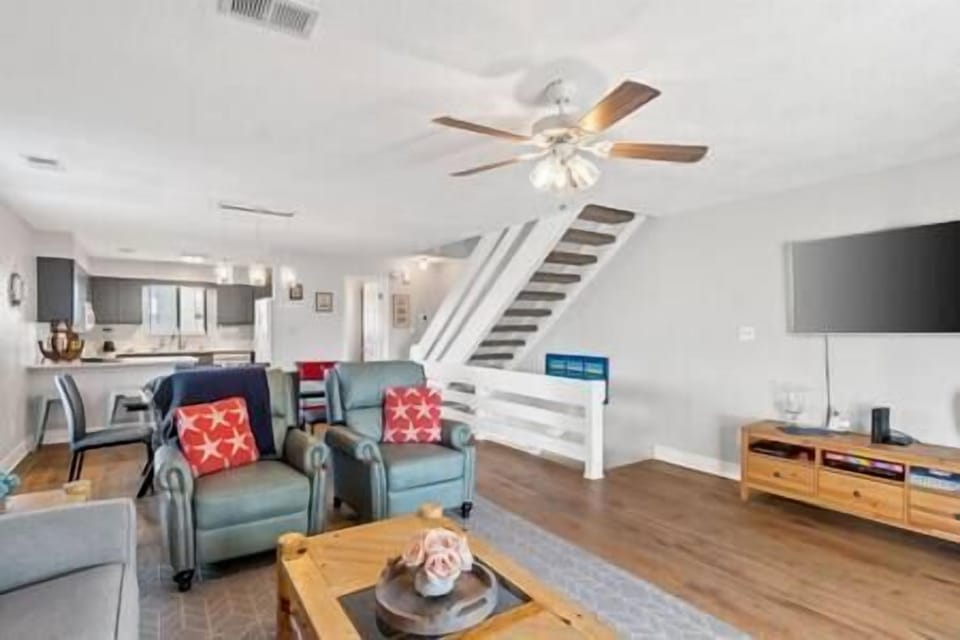 Stairs that go downstairs to the main entry and upstairs to the bedrooms and laundry.