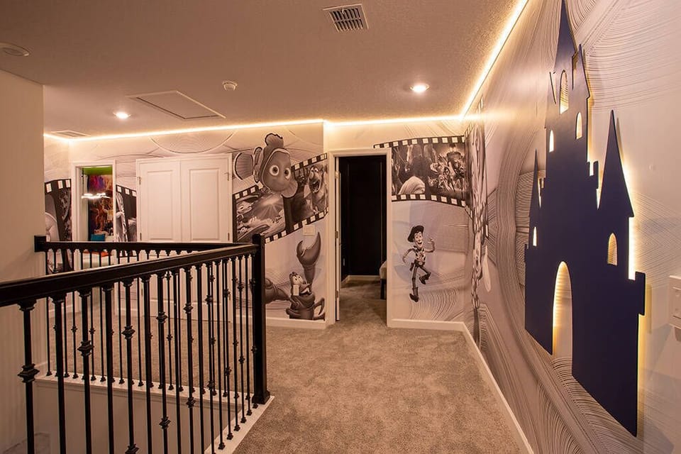 Step into a whimsical hallway adorned with vibrant murals that spark your imagination, featuring soft carpeting and warm recessed lighting, creating an enchanting atmosphere perfect for guests of all ages.