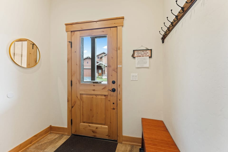 A bright entryway with warm wood accents and thoughtful details sets the tone for your mountain getaway, where rustic charm meets modern comfort.