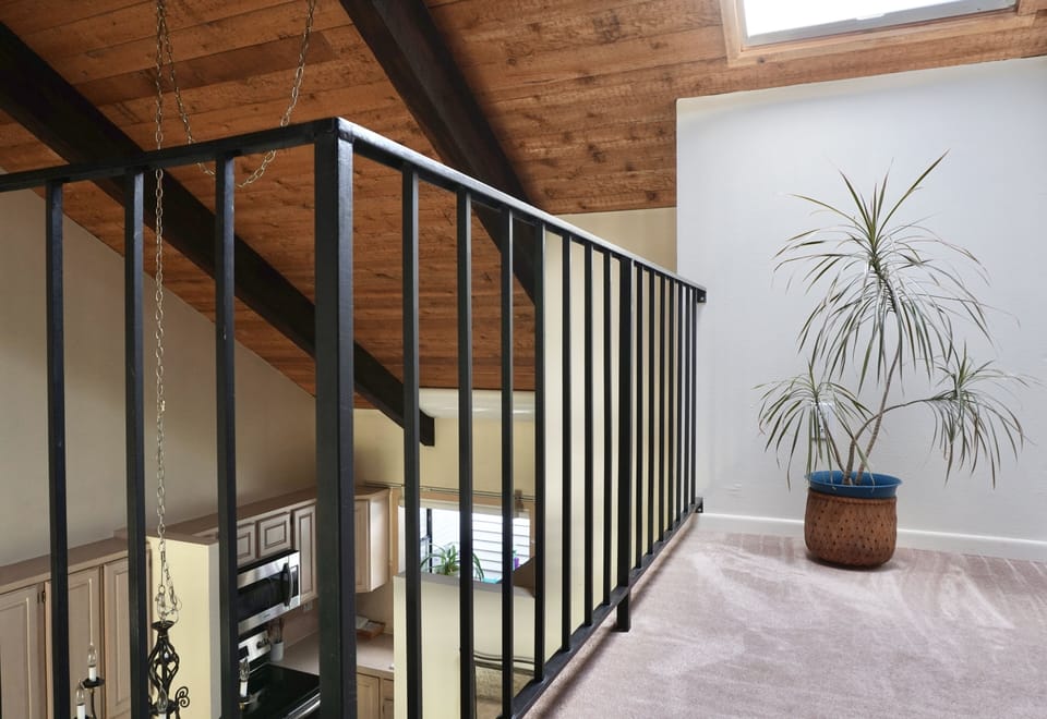 Loft with skylight overlooking kitchen, dining and living rooms.