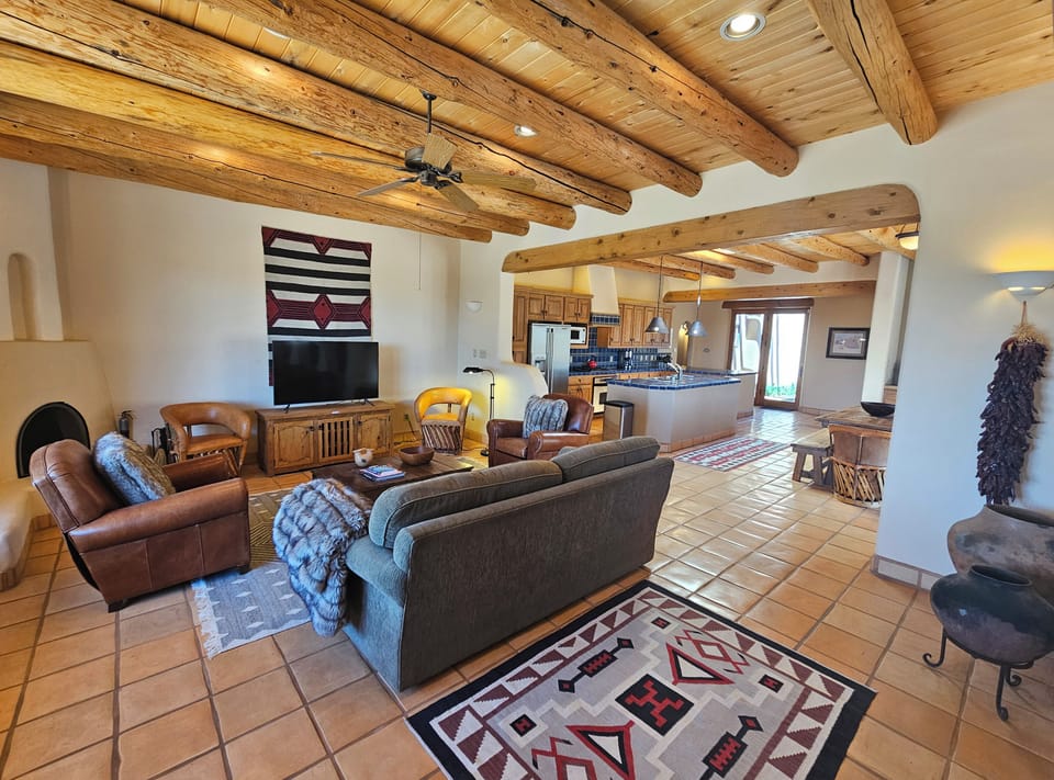 Spacious Livingroom looking toward kitchen with candle only kiva fireplace