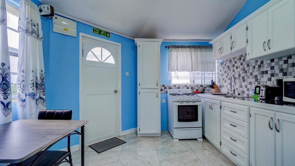 View of kitchen with small dining table and entrance door