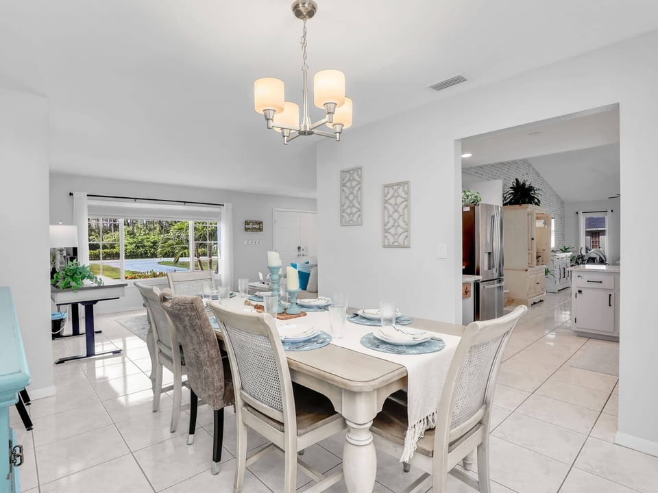 Casa Bonita Florida’s dining room and kitchen showcase coastal charm with pool views—blending comfort and style.