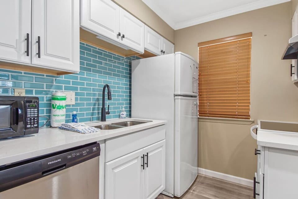 Kitchen with fridge, stove/over, dishwasher
