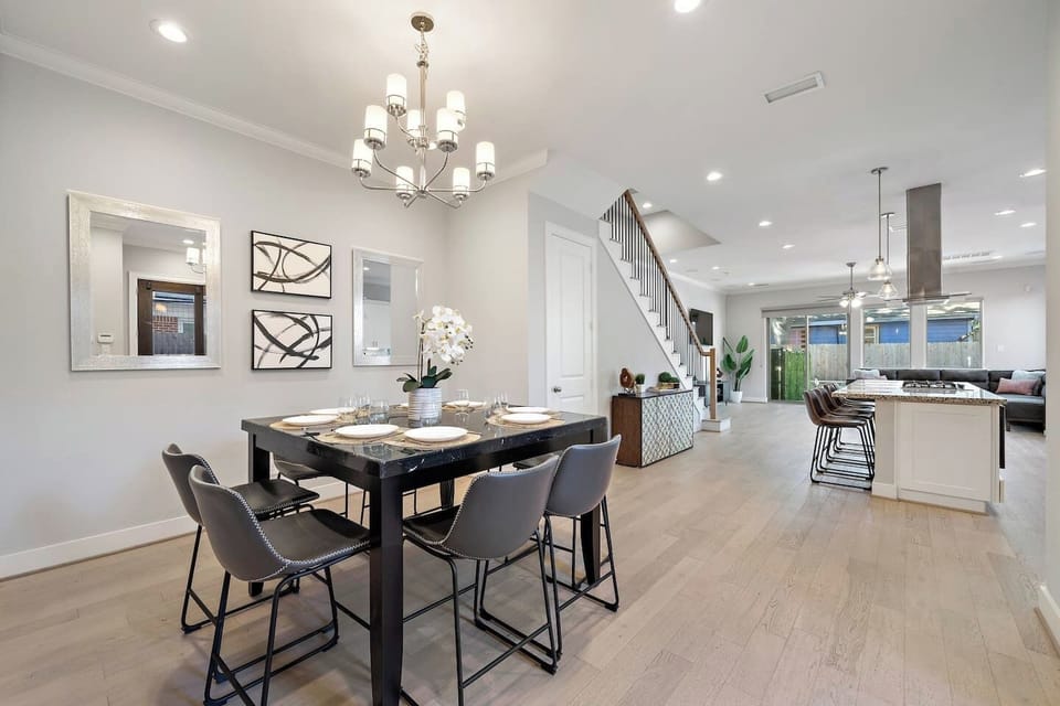 Countertop height dining room table for 8 with additional seating for 4 at the kitchen island.
