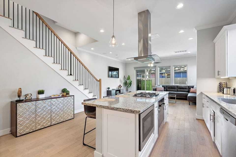 Welcome to this spacious modern kitchen that opens to both the living room and dining area. Kitchen island w/seating to entertain while you cook on the gas cooktop.
