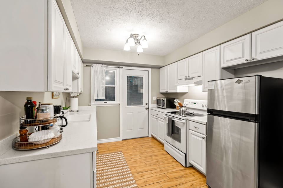 The fully-equipped kitchen includes a new Bosch dishwasher and full cooking supplies including blender, coffee maker, French press, microwave, crock-pot, cooking pots and pans, toaster, and more.