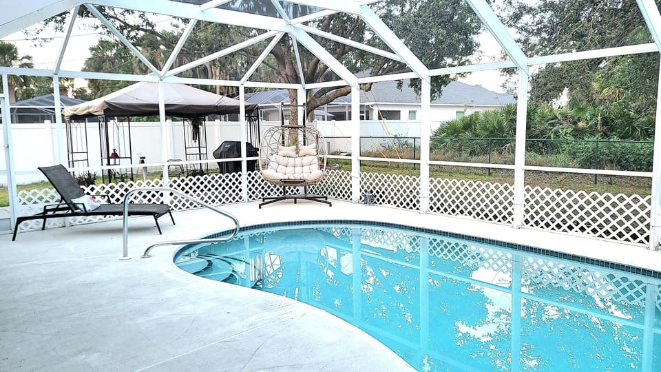 Pool deck with egg chair and lounger.
